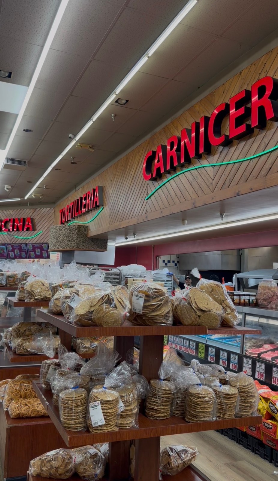 Packaged tostadas displayed beneath the tortilleria and carniceria signs at Carnival Chula Vista.