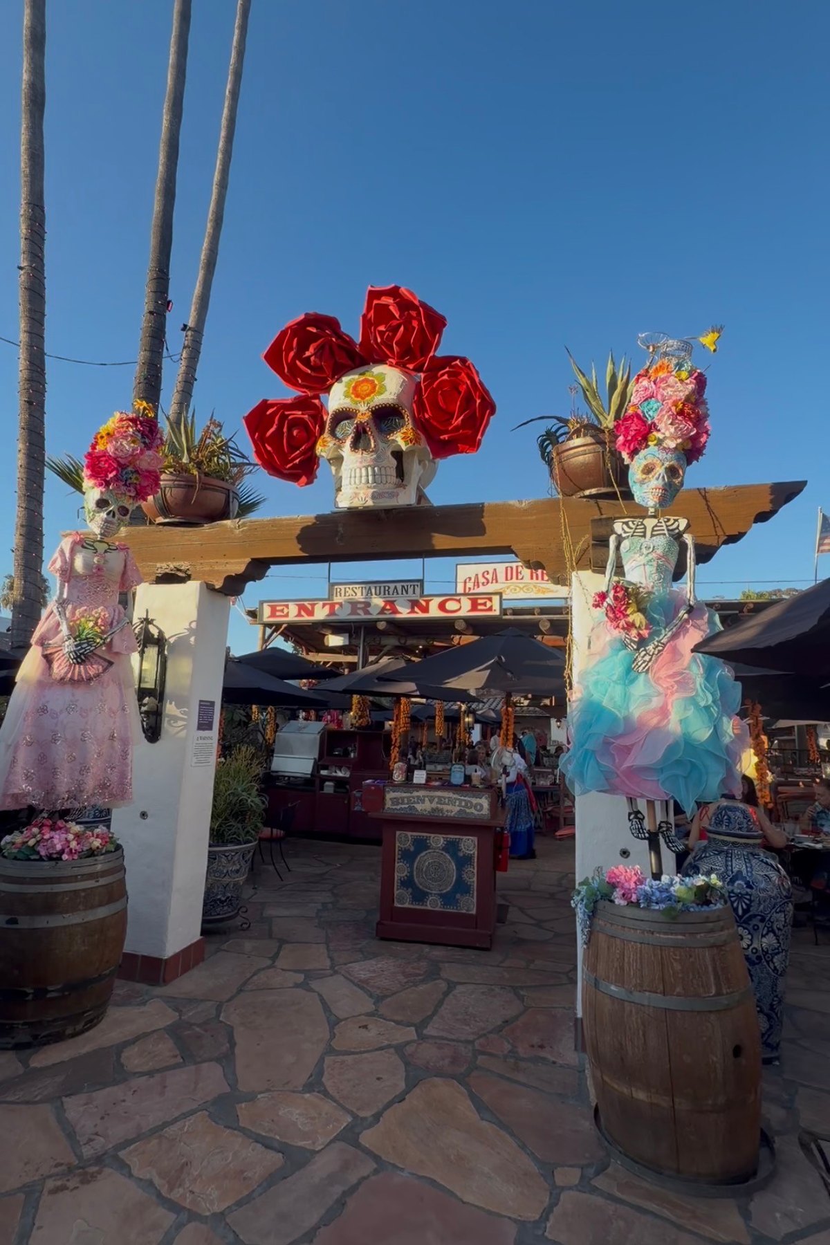 Painted skulls and flower-covered Catrinas frame the Casa de Reyes entrance in Old Town San Diego.