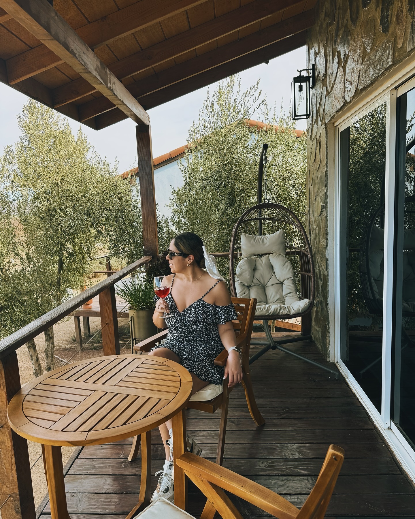 Giselle with a drink on a wooden terrace at Montevalle Resort and Spa.