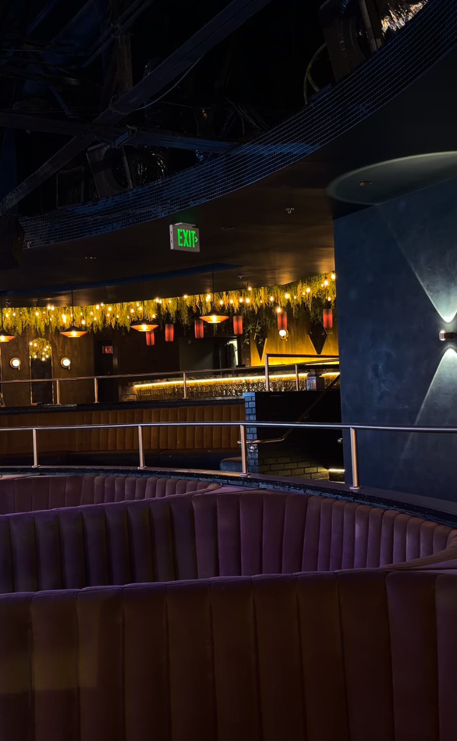 Curved lounge seating facing a warm-lit bar at The Quin.