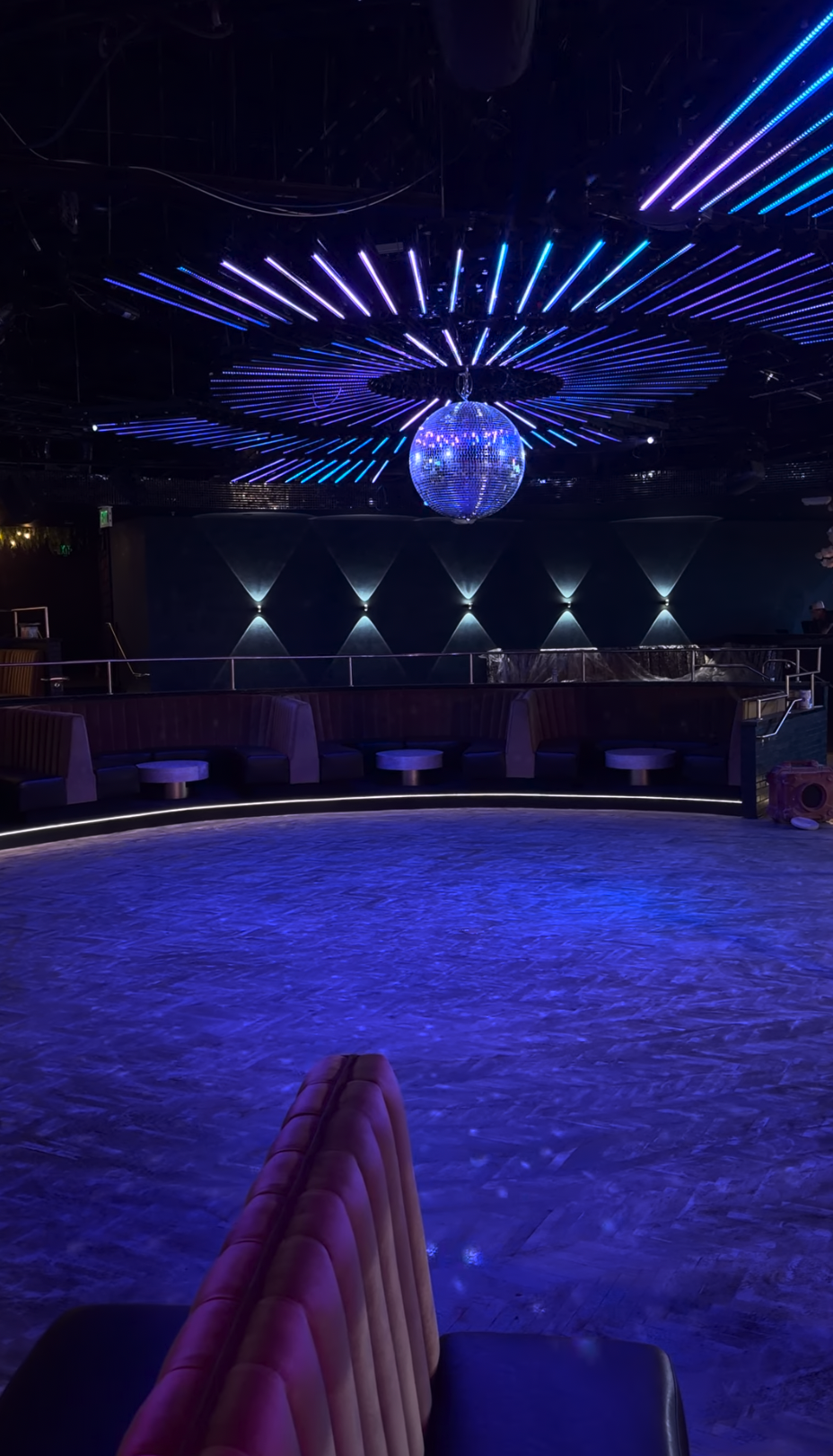 The Quin's dance floor beneath blue and purple ceiling lights and a disco ball.